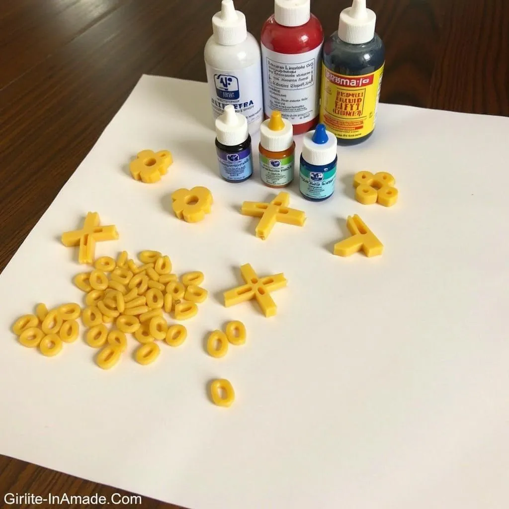 Colorful dry pasta, rubbing alcohol, and food coloring on a table.