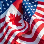 Canadian and American flags waving together