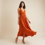 Nude pumps paired with a burnt orange cocktail dress