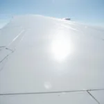 White Airplane Fuselage Reflecting Sunlight