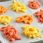 Drying colored pasta on parchment paper