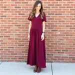 Woman wearing brown leather boots with a burgundy dress