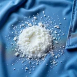 Close up of white deodorant buildup on a blue shirt