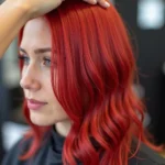 Applying red hair dye to blonde hair