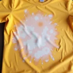 Bleach damage on colored shirt