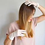 Woman applying color removing product to lighten her hair