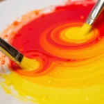 Mixing Red and Yellow Paint to Make Orange