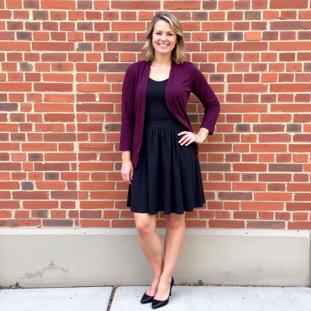 Woman in a black dress and purple cardigan