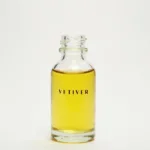 clear glass bottle filled with vetiver essential oil