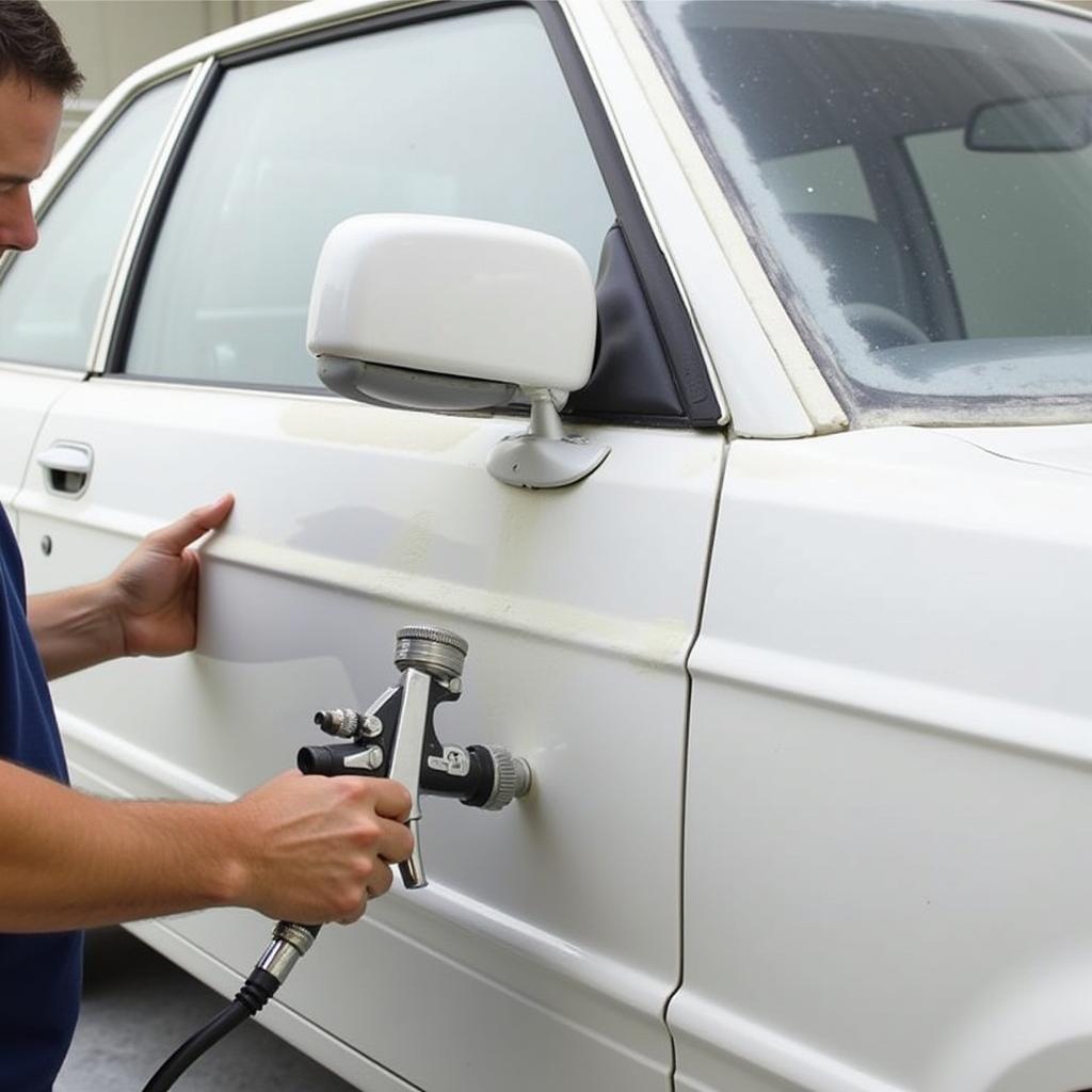 Applying Primer Evenly to Car Panel with Spray Gun