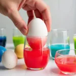 Dyeing Easter eggs with different Kool-Aid flavors to achieve vibrant colors.