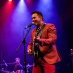 Ivan Cornejo performing on stage with dynamic lighting