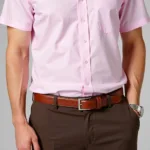 Man wearing a pink shirt with brown pants