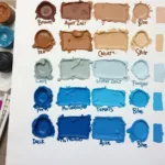 Mixing brown and blue paint on a palette creates various shades.