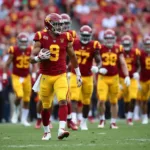 USC Trojans football team in cardinal and gold uniforms