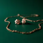 Rose Gold Jewelry with Emerald Green Background