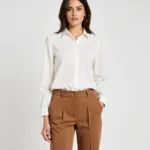 Woman in Brown Pants and a White Blouse